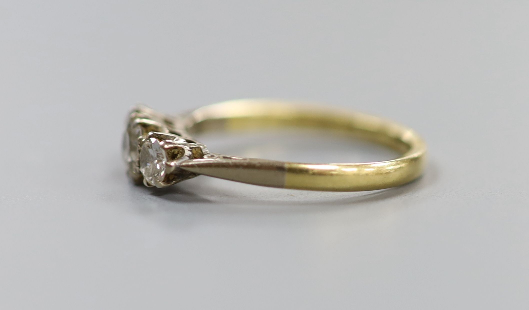 An 18ct & Pt, three stone diamond ring, size M, gross 2.4 grams.